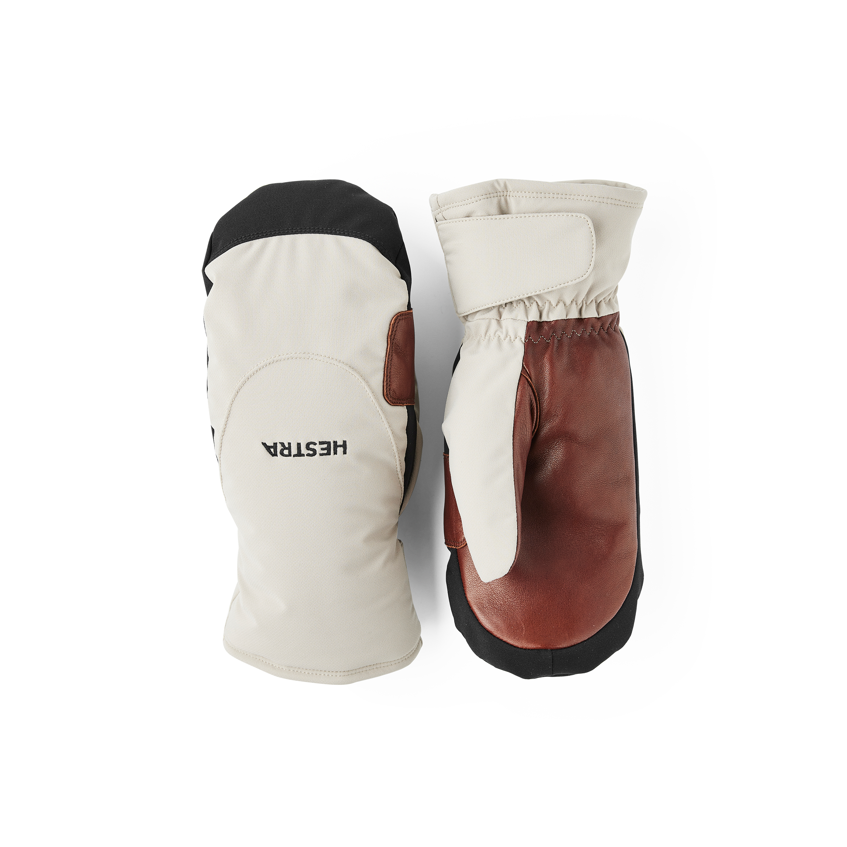 Beige tumhandske i tyg med mörkbrun lammnappa i innerhanden