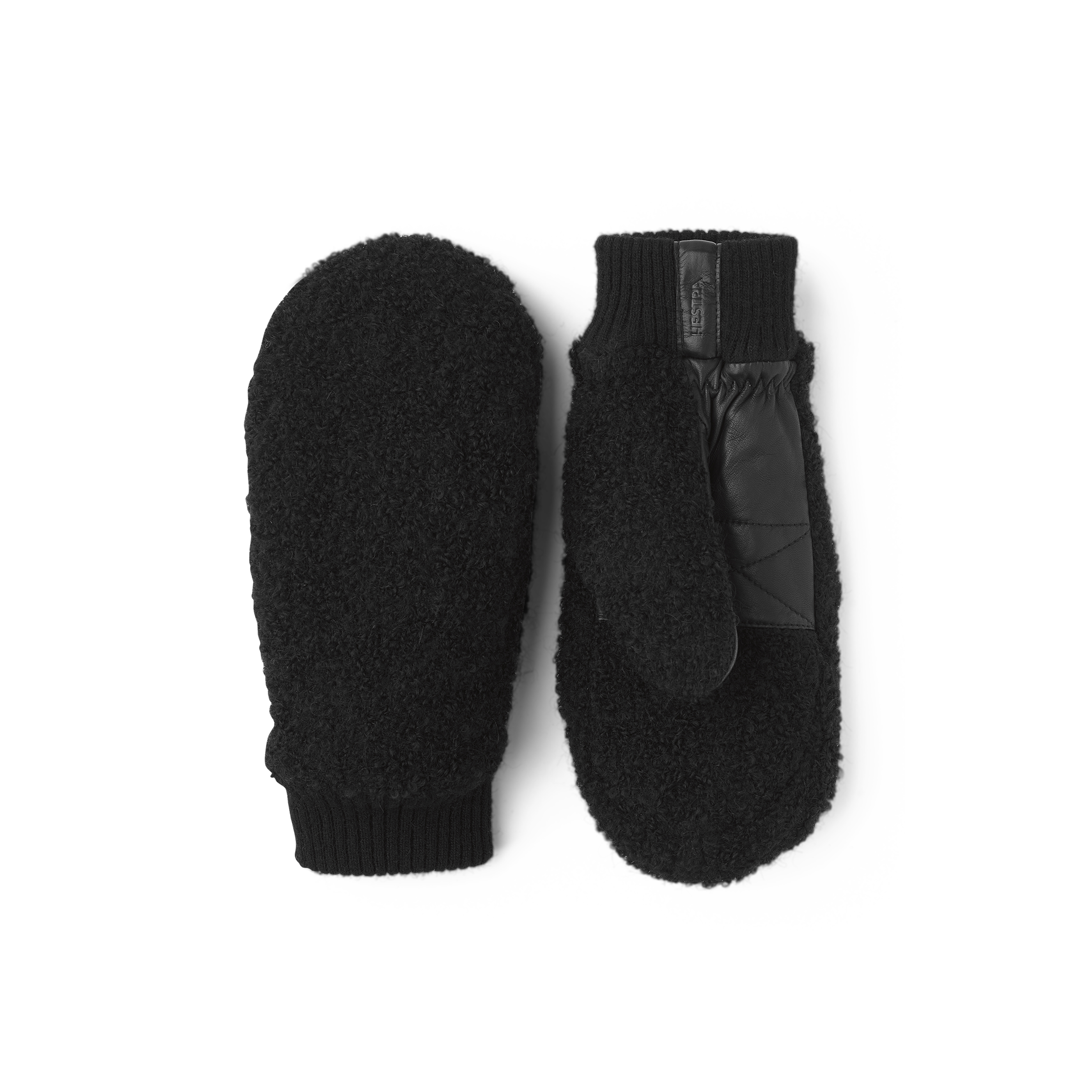 Svart tumhandske i teddyfleece med svart lammnappa i innerhanden